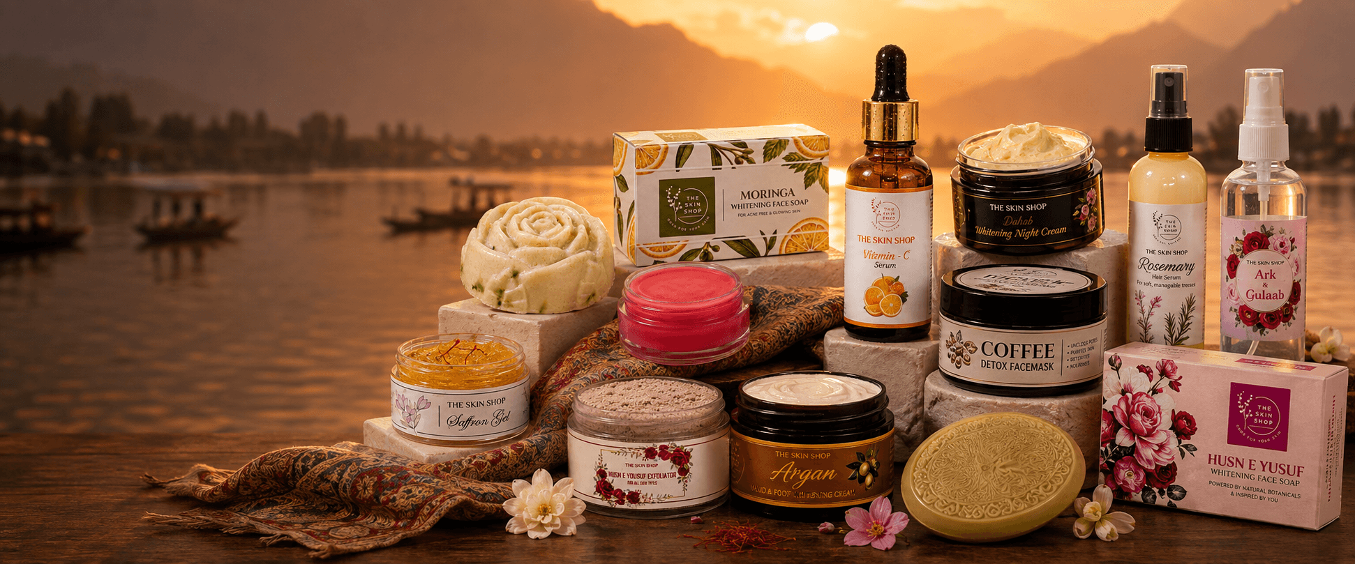 The Skin Shop's full skincare collection arranged before the Dal Lake at sunset in Kashmir